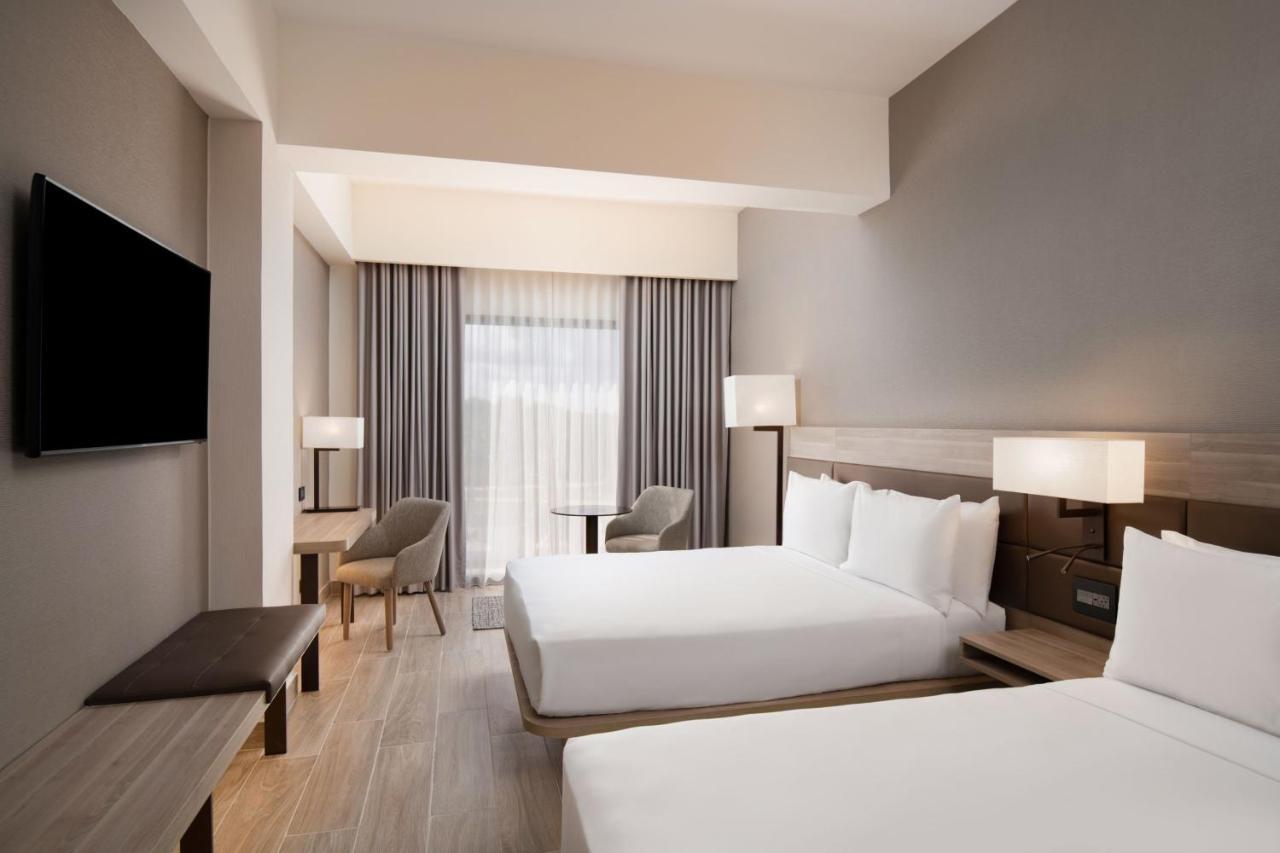 Deluxe Queen Room with Two Queen Beds and Pool View
